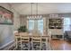 Bright dining area with a wooden table, natural light, and an adjacent hutch at 29 Fern Leaf Ct, Dallas, GA 30157
