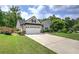 A charming single-Gathering home with well-maintained lawn, a driveway, and an attached two-car garage at 29 Fern Leaf Ct, Dallas, GA 30157