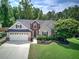 Charming home with manicured lawn, well-maintained landscaping, and a two-car garage offers great curb appeal at 29 Fern Leaf Ct, Dallas, GA 30157
