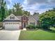 Charming two-story home featuring a brick facade, gray siding, well-manicured lawn, and an attached two-car garage at 29 Fern Leaf Ct, Dallas, GA 30157