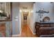 A long hallway features hardwood floors, neutral walls, decorative artwork, and elegant decor at 29 Fern Leaf Ct, Dallas, GA 30157