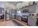 Modern kitchen with gray cabinetry, stainless steel appliances, and stylish decor at 29 Fern Leaf Ct, Dallas, GA 30157