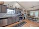 Charming kitchen with stainless appliances, gray cabinets, and an adjacent dining area at 29 Fern Leaf Ct, Dallas, GA 30157