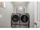 Well-equipped laundry room with front-loading washer and dryer at 29 Fern Leaf Ct, Dallas, GA 30157