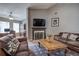 Cozy living room featuring leather sofas, a fireplace, and a large television at 29 Fern Leaf Ct, Dallas, GA 30157