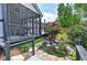 Beautiful backyard pond and waterfall feature lush landscaping and mature trees at 29 Fern Leaf Ct, Dallas, GA 30157