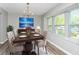 Bright dining room features large windows, a modern chandelier, and stylish decor at 5477 Hedgeflower Ct, Stone Mountain, GA 30088