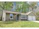Charming single-story home with stone accents, a well-manicured lawn, and an attached two-car garage at 5477 Hedgeflower Ct, Stone Mountain, GA 30088