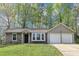 Charming single-story home boasts an attached two-car garage and beautifully landscaped front yard at 5477 Hedgeflower Ct, Stone Mountain, GA 30088