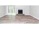 Living room with a sliding door to the back, an ornate fireplace, and laminate flooring at 5477 Hedgeflower Ct, Stone Mountain, GA 30088