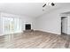 Spacious living room with a cozy fireplace and sliding glass doors to the outside at 5477 Hedgeflower Ct, Stone Mountain, GA 30088
