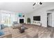 Bright living room featuring stylish furnishings, a fireplace, and a mounted flat screen TV at 5477 Hedgeflower Ct, Stone Mountain, GA 30088