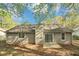 Rear exterior view highlighting siding, a chimney, and a small patio area at 5477 Hedgeflower Ct, Stone Mountain, GA 30088