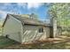 The rear of the house shows vinyl siding, a small patio, and fenced yard at 5477 Hedgeflower Ct, Stone Mountain, GA 30088