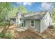 The rear of the house has vinyl siding, chimney, sliding door and a small patio area at 5477 Hedgeflower Ct, Stone Mountain, GA 30088