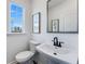 Modern powder room with a pedestal sink, sleek fixtures and a window view at 95 Wilder Ridge Way, Lawrenceville, GA 30044