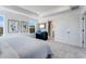 Bright bedroom features tray ceiling, neutral carpet and decor, and ensuite bath at 95 Wilder Ridge Way, Lawrenceville, GA 30044