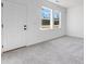 Empty bedroom with gray carpet, natural light, and a view of the trees outside at 95 Wilder Ridge Way, Lawrenceville, GA 30044