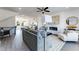 Spacious living room with gray sofa, fireplace and an open concept connecting to the kitchen at 95 Wilder Ridge Way, Lawrenceville, GA 30044