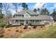 Charming home features a wide porch, manicured landscaping and a classic, welcoming facade at 9549 Clear Lake Court, Douglasville, GA 30135