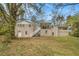 Back exterior view of home, deck, and grassy backyard at 3129 Thrasher Cir, Decatur, GA 30032