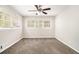 Cozy bedroom with gray carpet, neutral walls, white trim, and natural light from three windows at 3129 Thrasher Cir, Decatur, GA 30032