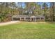 Charming single-story home featuring a brick exterior, a carport, and a spacious front yard at 3129 Thrasher Cir, Decatur, GA 30032