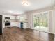 Well-lit eat-in kitchen featuring white cabinets, stainless steel appliances, and sliding glass doors to a patio at 3129 Thrasher Cir, Decatur, GA 30032