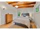 Bedroom with hardwood floors, wooden beam ceiling, and a wooden dresser at 3185 Laventure Dr, Chamblee, GA 30341