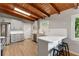 Modern kitchen featuring white cabinets, quartz countertops, stainless steel appliances, and a wood beam ceiling at 3185 Laventure Dr, Chamblee, GA 30341