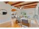 Inviting living room boasts hardwood floors, exposed wood beams, and natural light, seamlessly flowing into the dining area at 3185 Laventure Dr, Chamblee, GA 30341