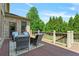 Inviting back deck offers serene outdoor seating with wooded views and a tranquil setting at 5330 Cole Creek Ln, Cumming, GA 30040
