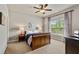 Bedroom featuring carpet, ceiling fan, and a bright window at 5330 Cole Creek Ln, Cumming, GA 30040