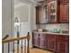 Elegant butler's pantry with wood cabinets, granite countertop, and glass door upper cabinets at 5330 Cole Creek Ln, Cumming, GA 30040