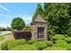 Stone entrance to Vickery Springs neighborhood with manicured landscaping on a bright sunny day at 5330 Cole Creek Ln, Cumming, GA 30040