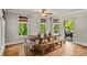 Bright dining room featuring a rustic wood table, seating for eight, and a patio door at 5330 Cole Creek Ln, Cumming, GA 30040