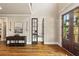 Grand foyer with hardwood floors, paneled entry door, and glass French doors to another room at 5330 Cole Creek Ln, Cumming, GA 30040