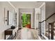 Bright foyer with hardwood floors and open doorway to landscaped exterior at 5330 Cole Creek Ln, Cumming, GA 30040