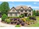 Beautiful brick home with a manicured front yard and lush landscaping at 5330 Cole Creek Ln, Cumming, GA 30040