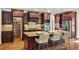 Open kitchen boasts a center island, stainless appliances, granite counters and a large walk-in pantry at 5330 Cole Creek Ln, Cumming, GA 30040