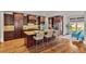 Spacious kitchen features a large island, granite countertops, dark wood cabinetry, and stainless appliances at 5330 Cole Creek Ln, Cumming, GA 30040