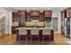 Stunning kitchen features a large island, granite countertops, stainless appliances, and dark wood cabinetry at 5330 Cole Creek Ln, Cumming, GA 30040