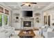 Bright living room with coffered ceiling, fireplace, and large windows with view of outside greenery at 5330 Cole Creek Ln, Cumming, GA 30040