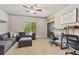 Spacious living room with a comfortable sofa, workspace, and natural light at 5330 Cole Creek Ln, Cumming, GA 30040