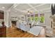 Open living room featuring coffered ceilings, a stone fireplace, and hardwood floors at 5330 Cole Creek Ln, Cumming, GA 30040