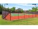 Community tennis courts with lighting and well-maintained surface for recreational enjoyment at 5330 Cole Creek Ln, Cumming, GA 30040