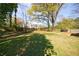 Expansive backyard featuring mature trees and a lush lawn, ideal for outdoor activities and relaxation at 1019 Magbee Se Dr, Smyrna, GA 30080