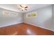 Bright bedroom with hardwood floors, ceiling fan, and large windows at 1019 Magbee Se Dr, Smyrna, GA 30080