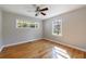 Bedroom with hardwood floors, ceiling fan, and natural light from exterior windows at 1019 Magbee Se Dr, Smyrna, GA 30080