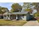 Charming light green home with a welcoming front porch and well-manicured lawn, perfect for curb appeal at 1019 Magbee Se Dr, Smyrna, GA 30080